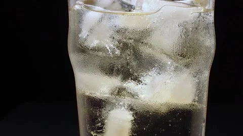 Glass with ice filled with ginger ale Stock Footage 134883649