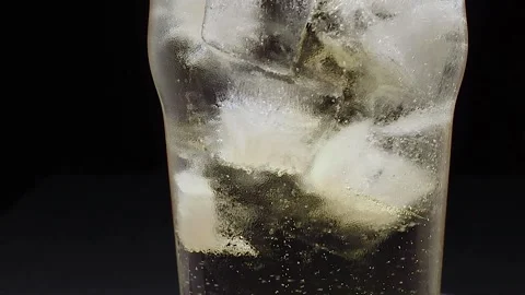 Glass with ice filled with ginger ale Stock Footage 134883666