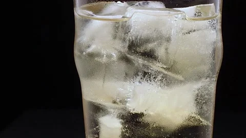 Glass with ice filled with ginger ale Stock Footage 134883680