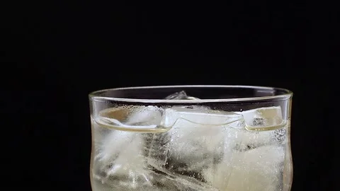 Glass with ice filled with ginger ale Stock Footage 134883686