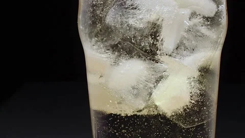 Glass with ice filled with ginger ale Stock Footage 134883692