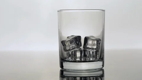 A glass of ice filled with whiskey Stock Footage