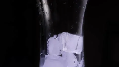 Glass with ice rotates close-up Stock Footage 146523039
