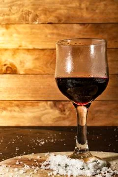 Glass of iced red wine in a rustic setting. Stock Photos