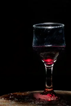 Glass of iced red wine in a rustic setting. Stock Photos