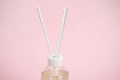 Glass jar for aromatic diffuser on pink background Stock-Fotos