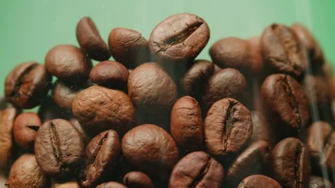 Glass jar with coffee on black background with smoke. Coffee beans close-up Stock Footage 273505599