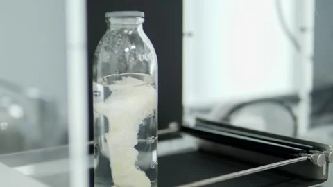 Glass jar filled with clear liquid. Laboratory equipment. Stock Footage 325610044