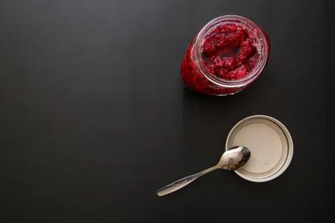 Glass Jar Full Of Raspberry Jam On Black Background. Stock Photos