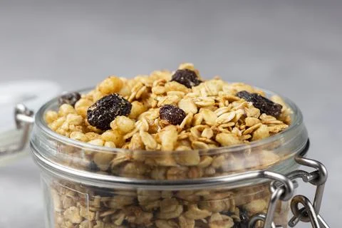Glass jar with granola on the table. Stock Photos