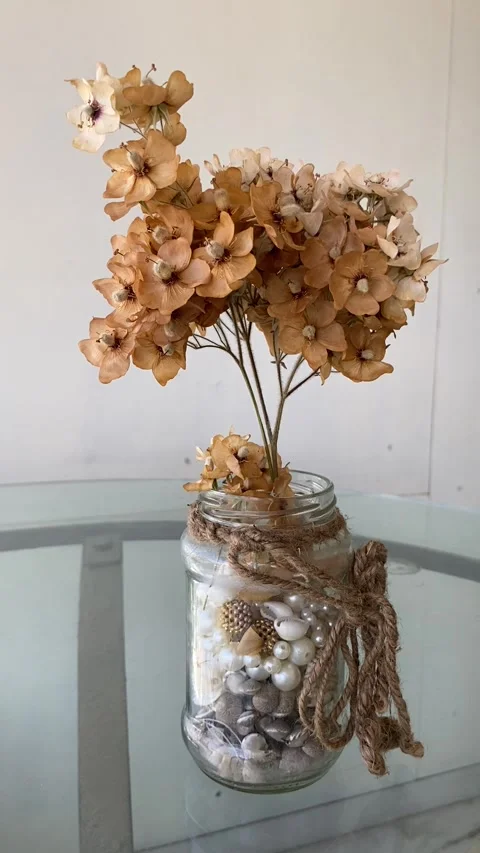 Glass jar holds delicate dry flowers Stock Footage 303639093