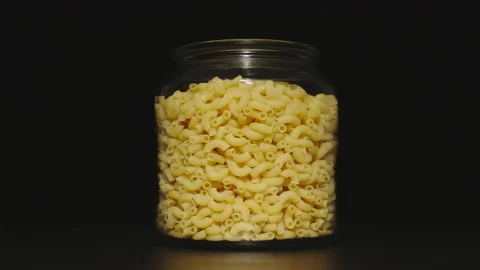 Glass jar with macaroni is getting empty. Stop Motion animation Stock Footage 134377079