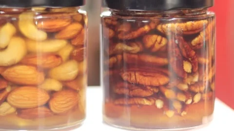 Glass jar of mixed nuts preserved in honey. Stock Footage 341447116