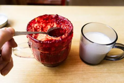 Glass jar with raspberry jam.   cup of milk or yogurt on wooden table. holdin Stock Photos