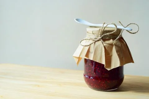 Glass jar of raspberry jam Stock Photos