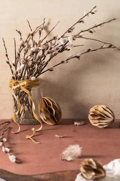 Glass jar with willow branches on rustic background. Easter season Stock Photos