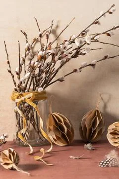 Glass jar with willow branches on rustic background. Easter season Stock Photos
