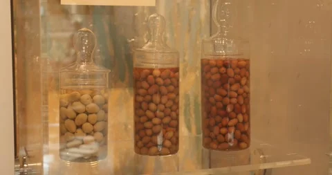 Glass jars filled with olives on display at Carlo Carli olive museum, Italy Video stock 345369925