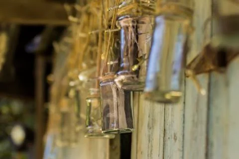 Glass Jars Hanging From String Outside A Broken Down Shed Stock Photos