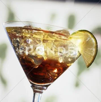 A glass of Kir (white wine with Crème de Cassis) on ice Stock Photos