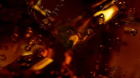 In a glass with large ice cubes black soda with bubbles Stock-Footage 122374983