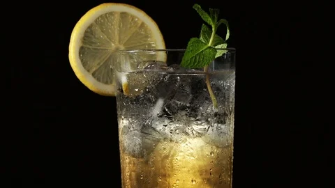 A glass of lemonade with ice mint and lemon Stock Footage 85860448