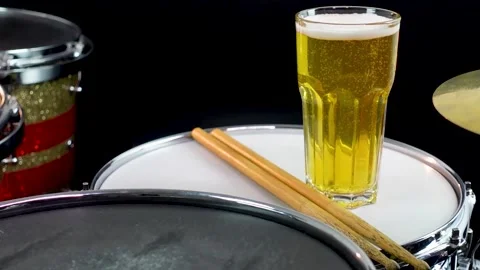 Glass of light beer on professional drum set closeup. Stock Footage 147940906