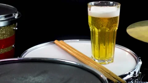 Glass of light beer on professional drum set closeup. Stock Footage 147940949