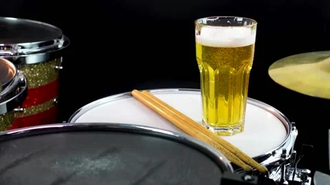 Glass of light beer on professional drum set closeup. Stock Footage 147940962
