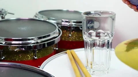 Glass of light beer on professional drum set closeup. Stock Footage 147940984