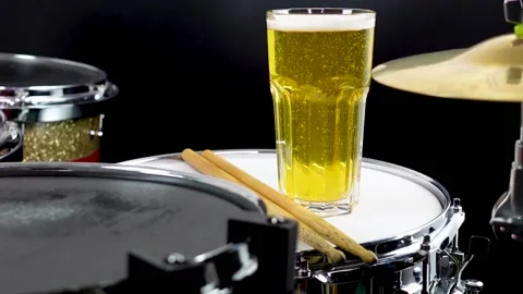 Glass of light beer on professional drum set closeup. Stock Footage 147940986