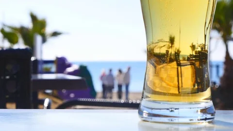 Glass of light beer on the table outdoors Stock Footage 73156989