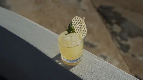 A glass of liquid with a small piece of white plastic on top Stock Footage 295993875
