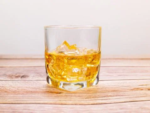 Glass for liquor Translucent elements made of glass are placed on a wooden .. Stock Photos