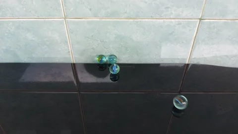 Glass marble balls playing rolling hitting clashing Stock Footage 209145494