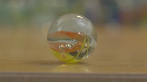 Glass marble toy close up on table Stock Footage 327517354