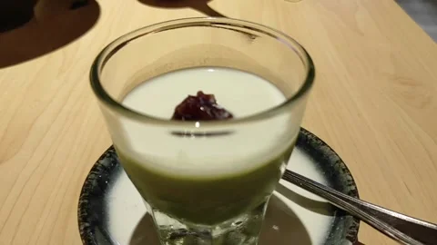 A glass of matcha pudding Stock Footage 261399951