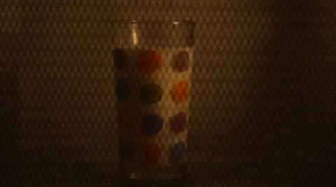 Glass of mik turning inside a microwave oven Stock Footage