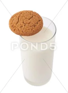 Glass of milk and cookie isolated over the white background Stock Photos