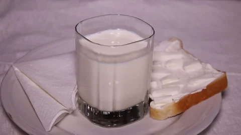 Glass Of Milk And Slice Of Bread Stock Footage 73084294