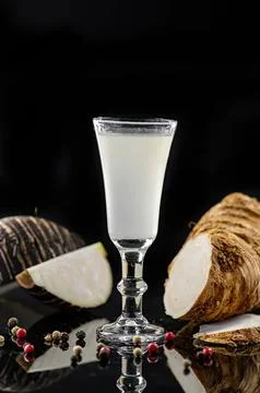 Glass of milk with bread and bread crumbs on black background Фото