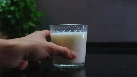 Glass of milk on dark background Stock Footage 242834732