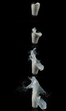 Glass for Milk exploding against Black Background Stock Photos