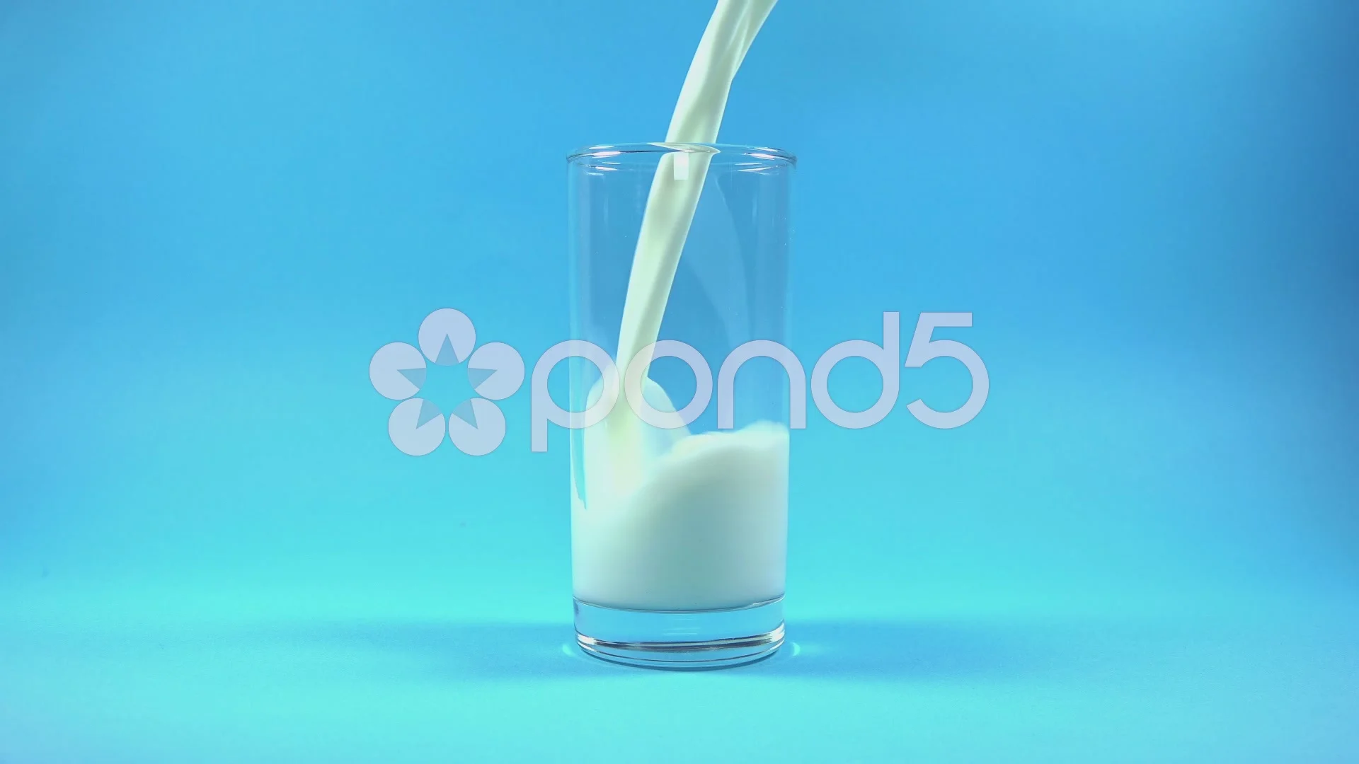 Glass of Milk with Pouring Splash on blu... | Stock Video | Pond5