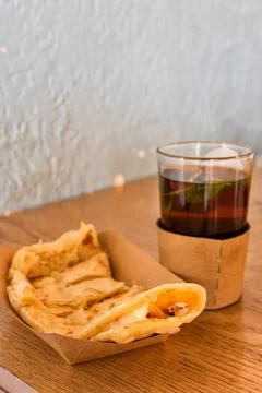 Glass of mint tea with chapati bread cheese and fries on a table Stock Photos