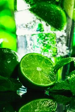 Glass of mojito with lime and mint close-up ice cube on a dark background Stock Photos