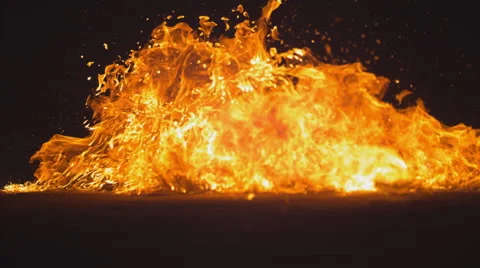 A glass molotov cocktail falls to the ground and explodes. Slow motion. Stock Footage