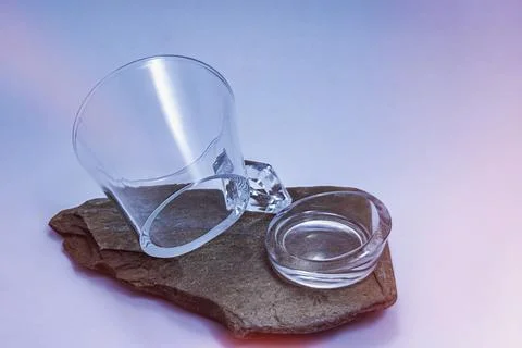 Glass mug broken by its base on slate Stock Photos