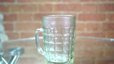 A glass mug on a table Stock Footage 134961183