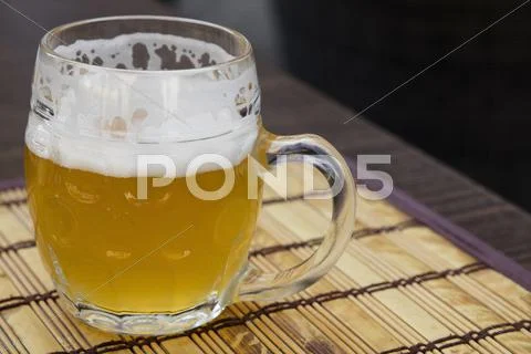 Glass mug of unfiltered weizen beer on table Stock Photos